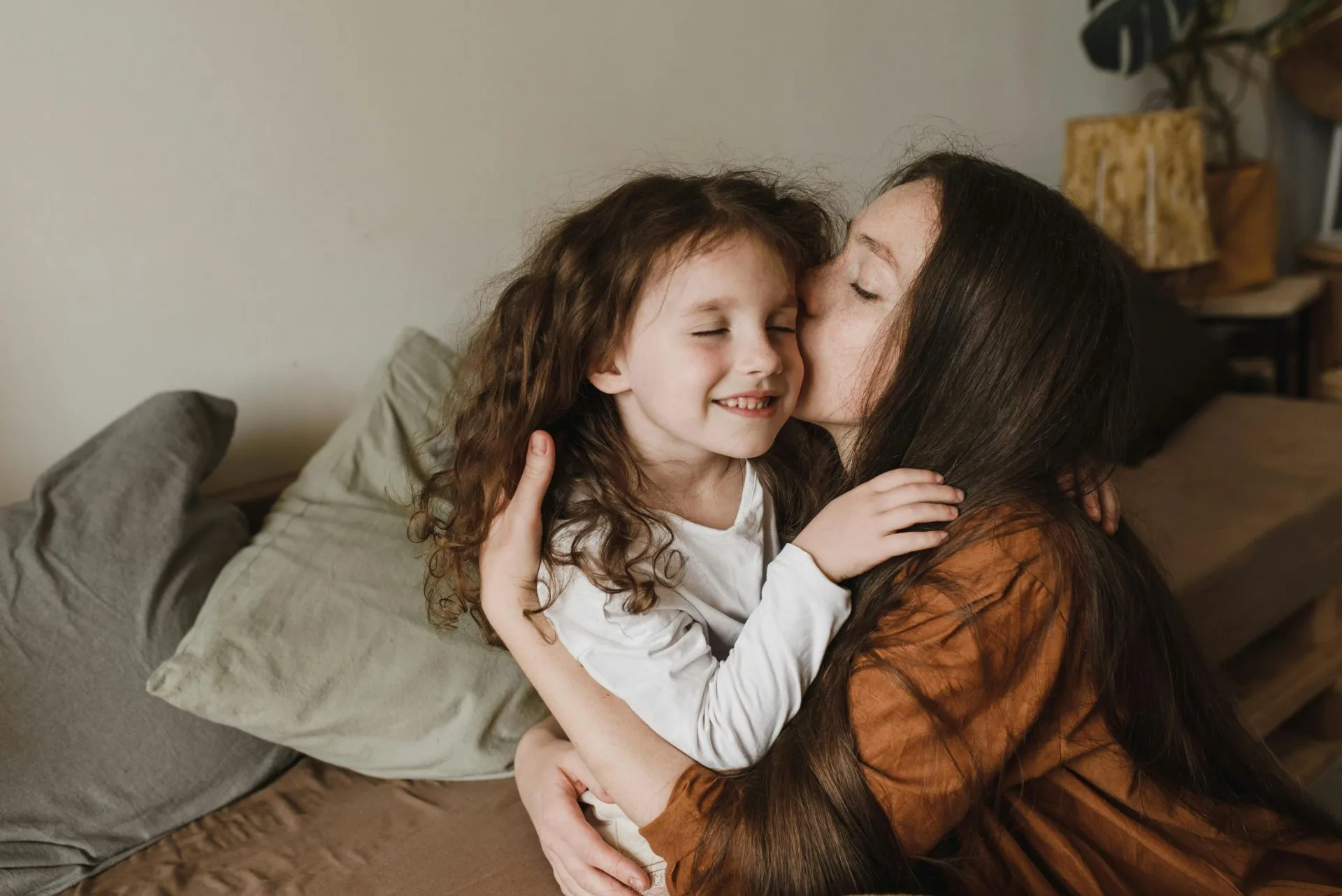 Mother and daughter embrace on couch, symbolizing family law support in Beaumont