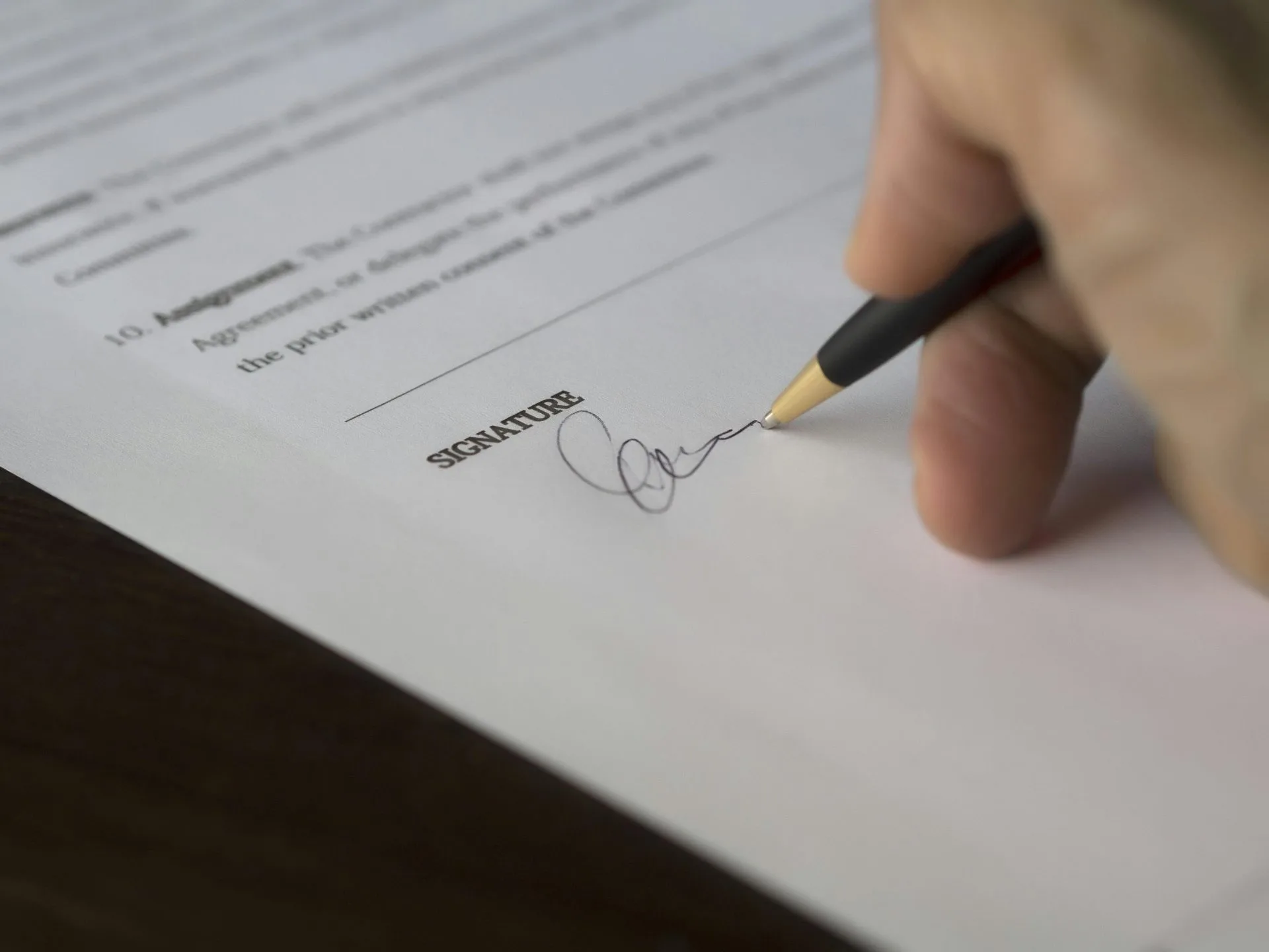 Client finalizing agreement with Hart Law's experienced notary services
